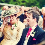 Mother of bride wipes away tears during ceremony at Bovey Castle wedding in devon