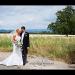 Somerset wedding couple in field with countryside in the background.