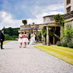 Devon Wedding at Bovey Castle bride arrives with bridesmaids on the terrace
