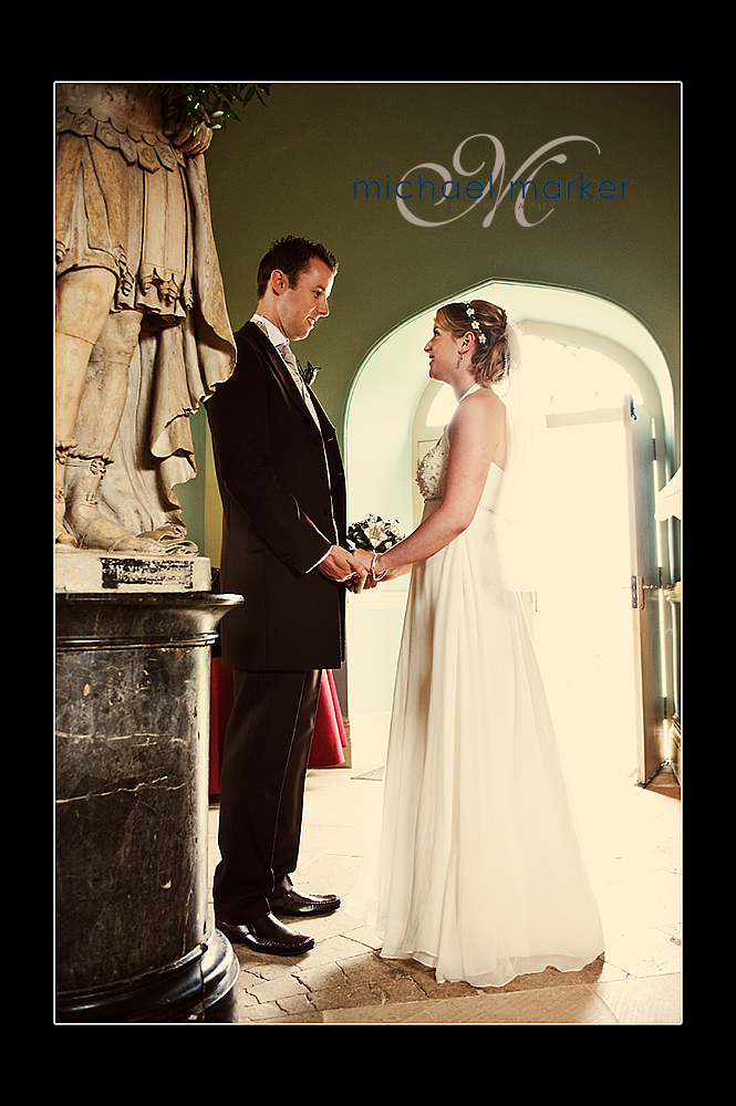 Bride and groom looking at each other in entrance hall of Haldon Belvedere wedding
