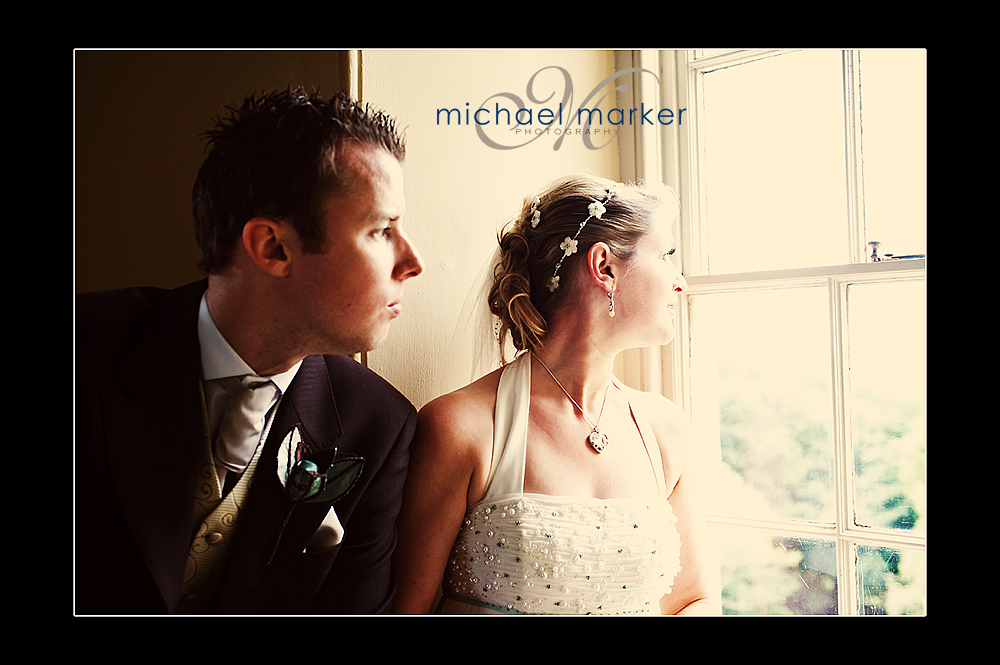 Bride and groom looking out of the staircase window at Haldon Belvedere wedding near Exeter