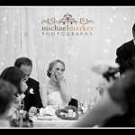 Bride laughing during father's wedding speech at Truro wedding in Cornwall