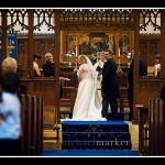 Bride and groom looking at congregation during Plymouth Church wedding