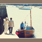 Bride and groom walking to Dittisham ferry at Darmouth summer wedding
