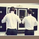 Ushers using reflection in Devon pub window to get ready for Devon wedding
