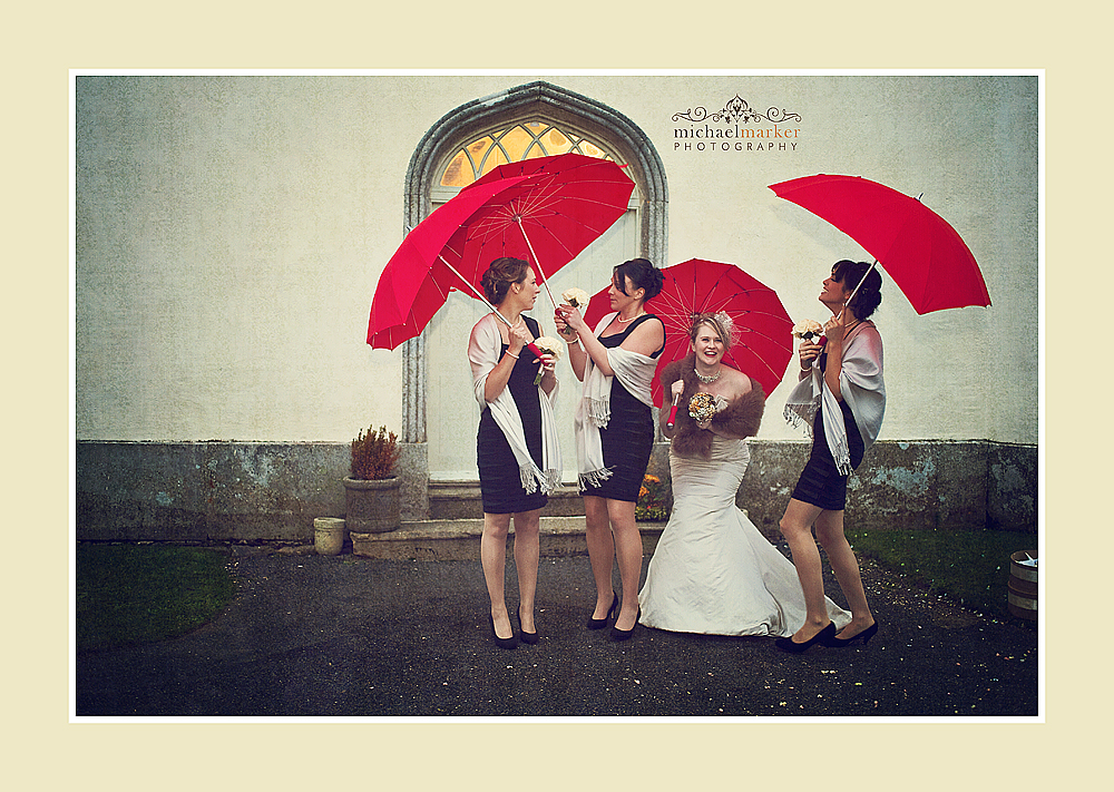 Brides and bridesmaids with red heart shaped unbrellas