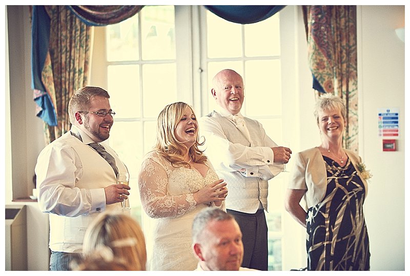 Photo of bride and groom laughter during the wedding speeches in Devon wedding