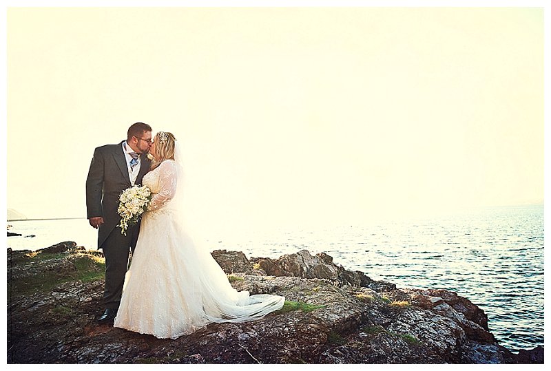 Couple kissing on rocks at Berry Head Hotel weddign in Devon