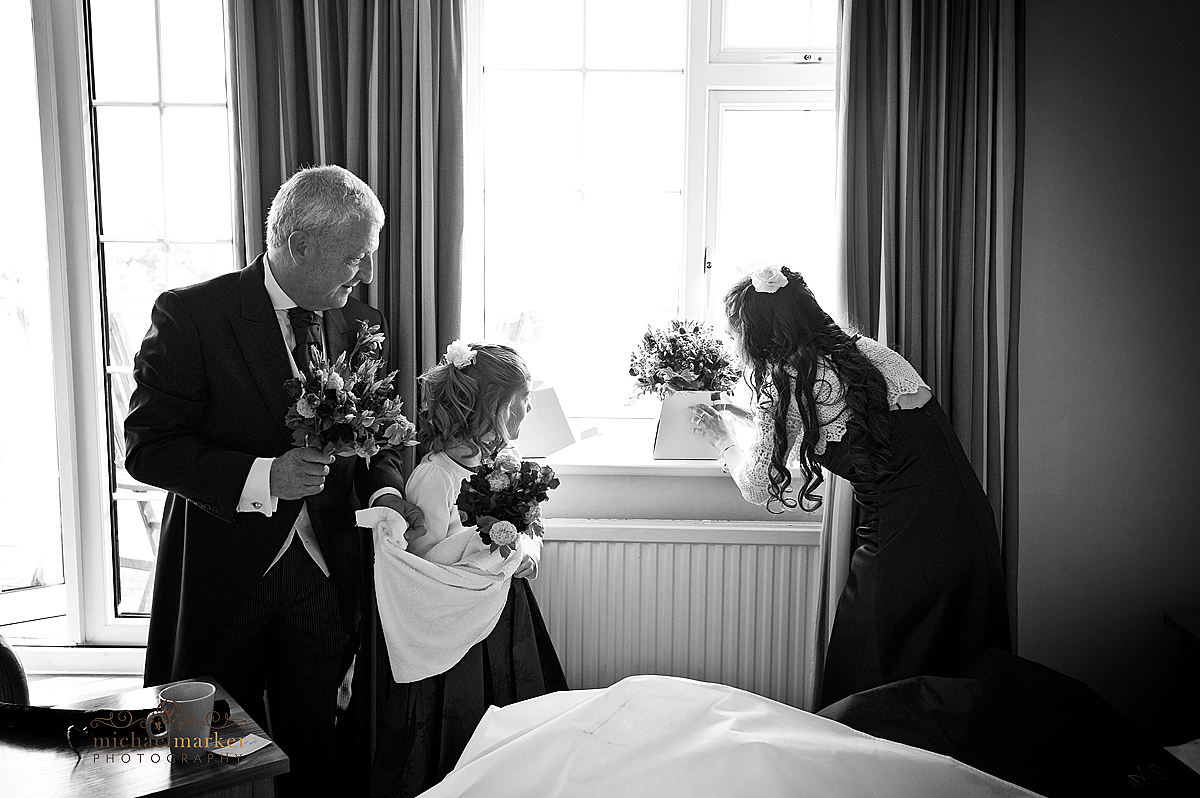 Father of the bride and bridesmaids drying flowers before the wedding