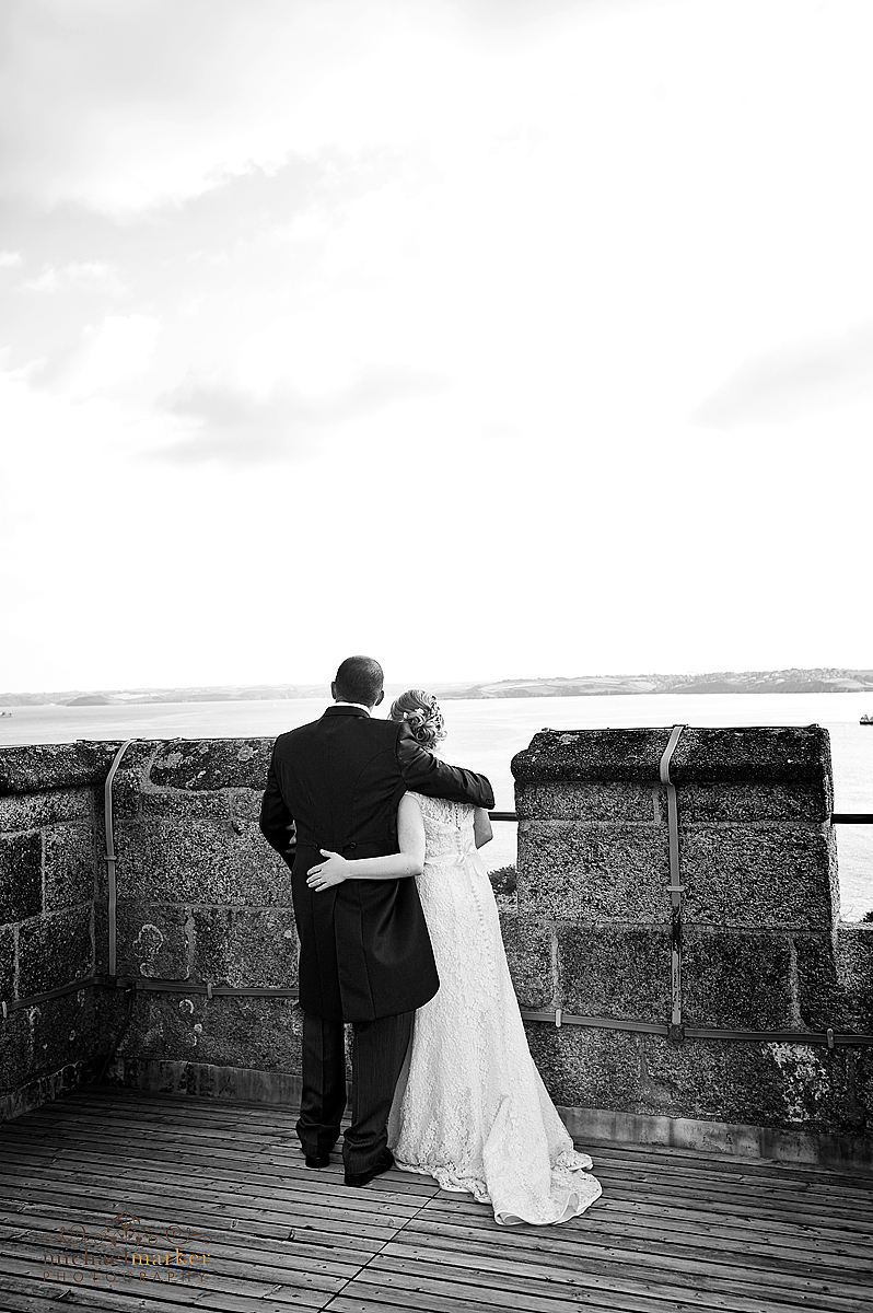 Pendennis Castle wedding photography Bride and groom looking out over Falmouth bay from the top of Pendennis Castle