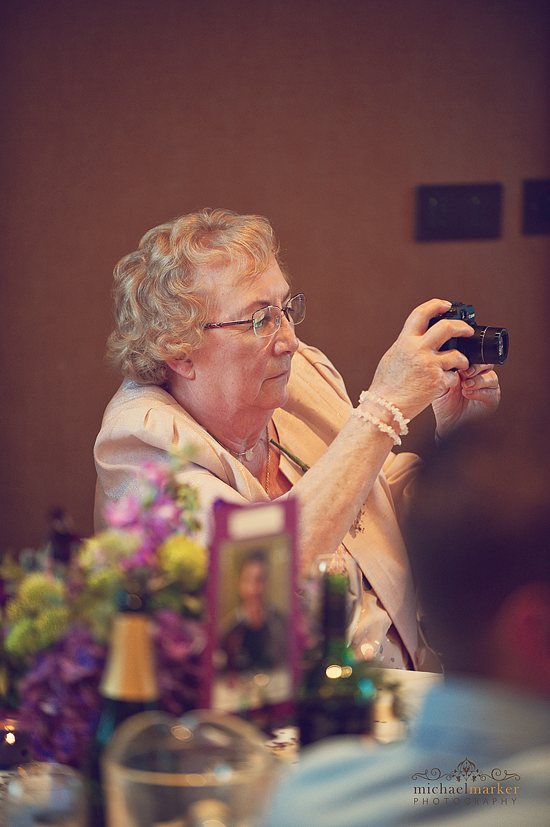 Guest taking photo at Falmouth wedding during speeches