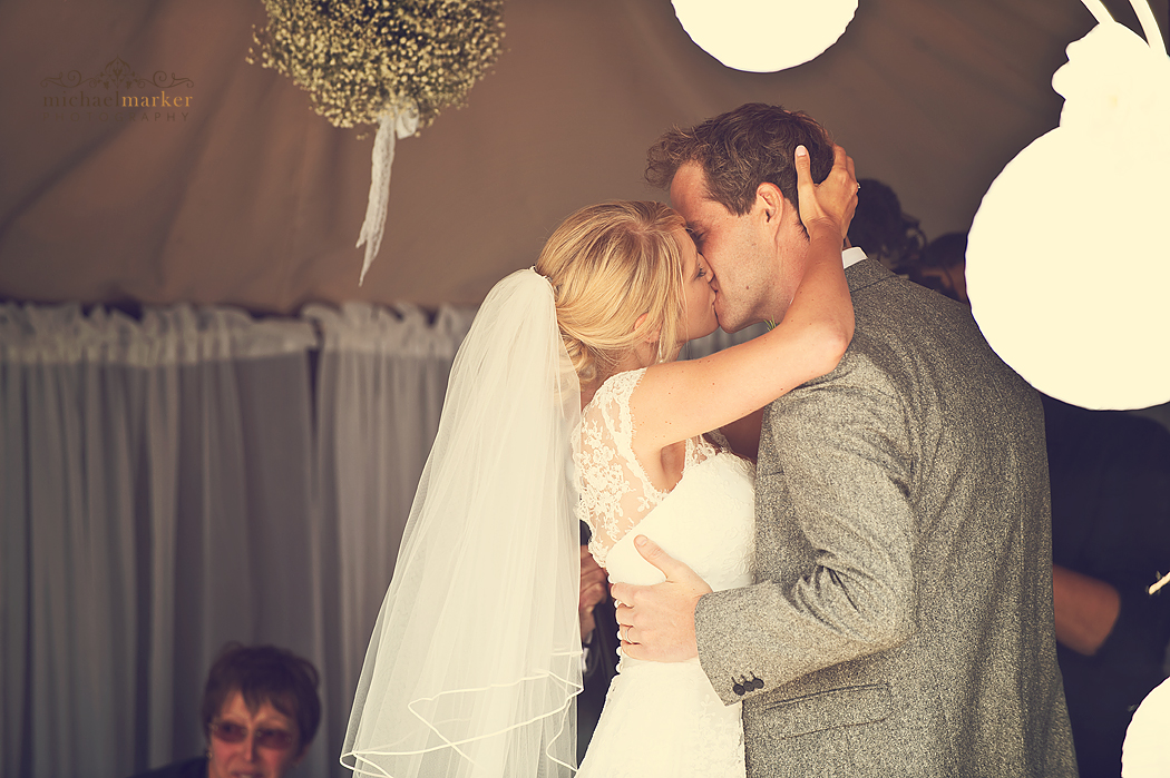 Bride and groom kiss at Polhawn Fort wedding ceremony