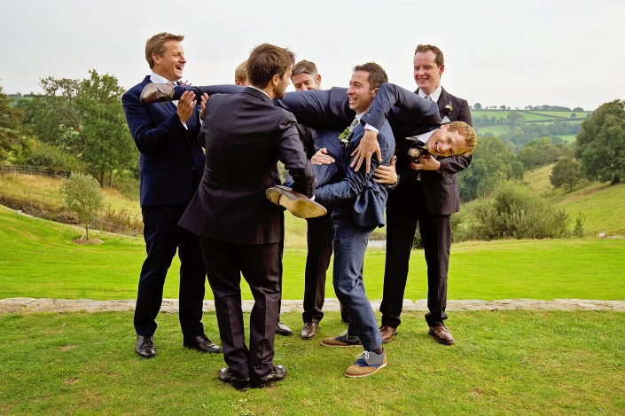 Ushers almost drop the groom at outddor wedding in Devon