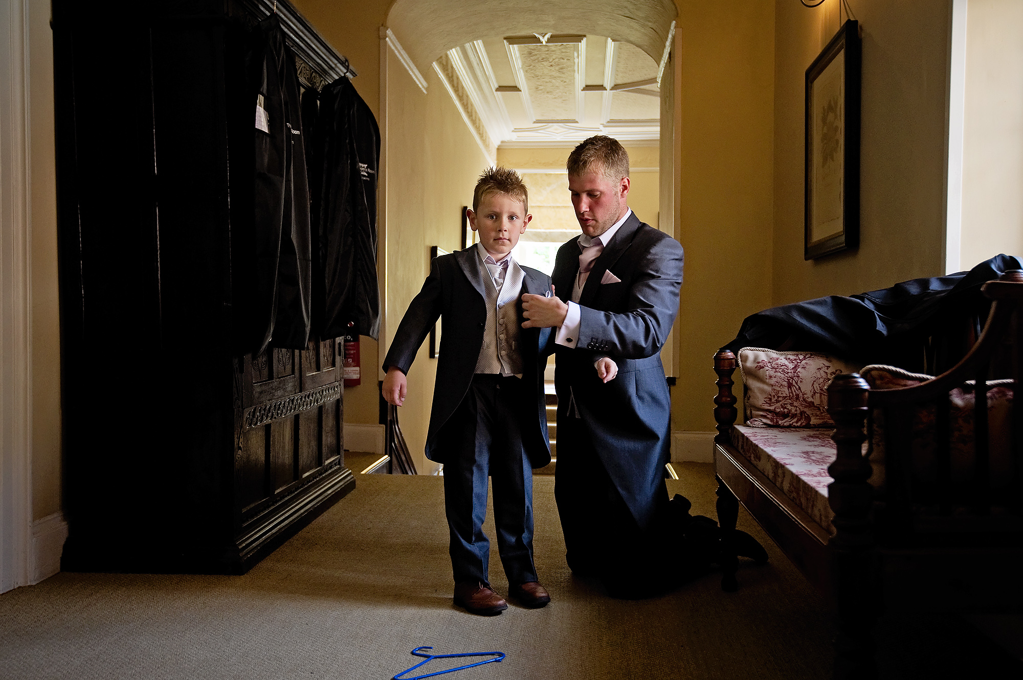 Pageboy getting dressed at Langdon Court wedding