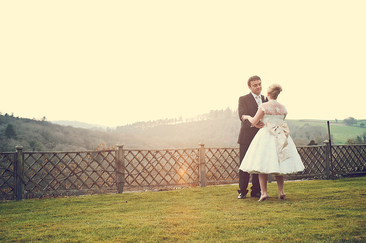 Bride and groom on garden terrace at Hotel Endsleigh in devon