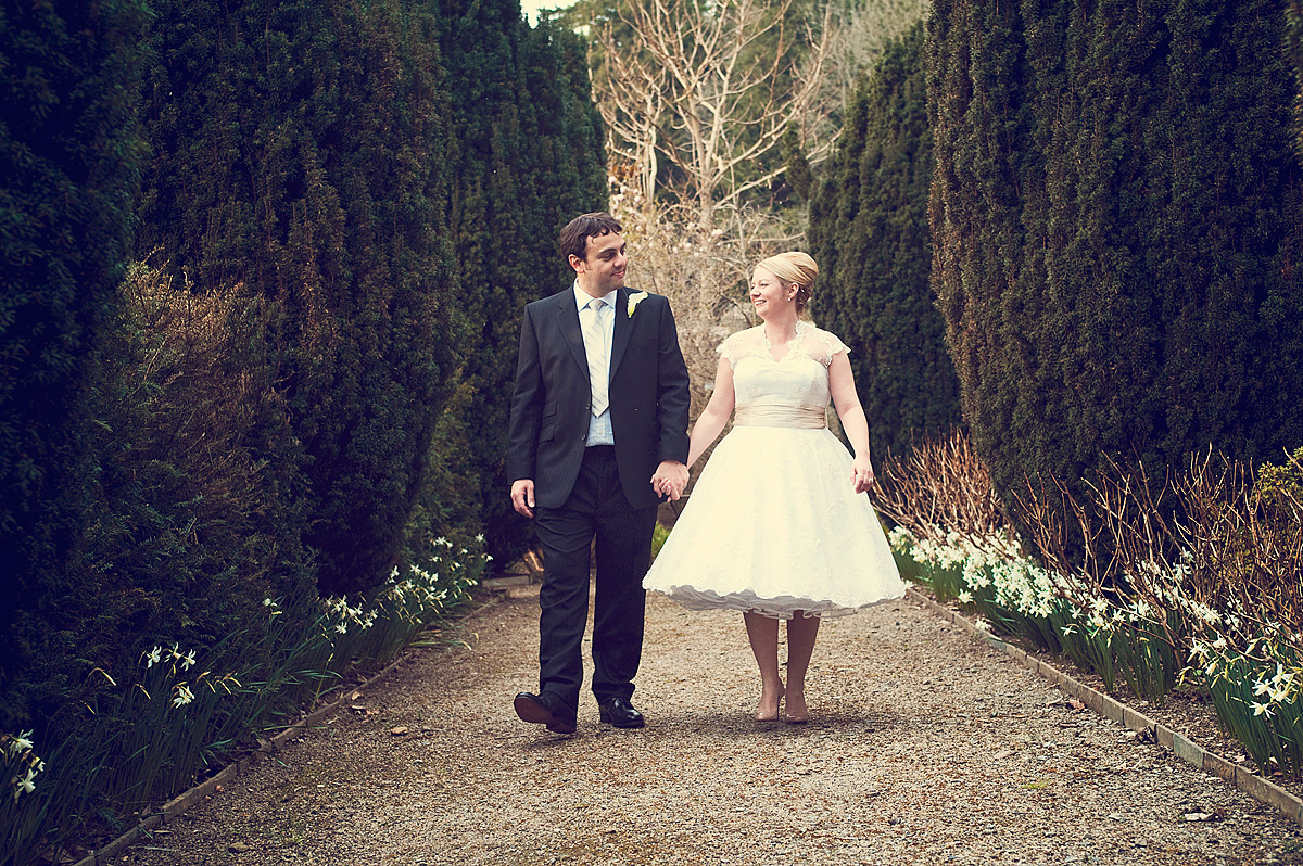 Wedding couple walking hand in hand at Hotel Endsleigh