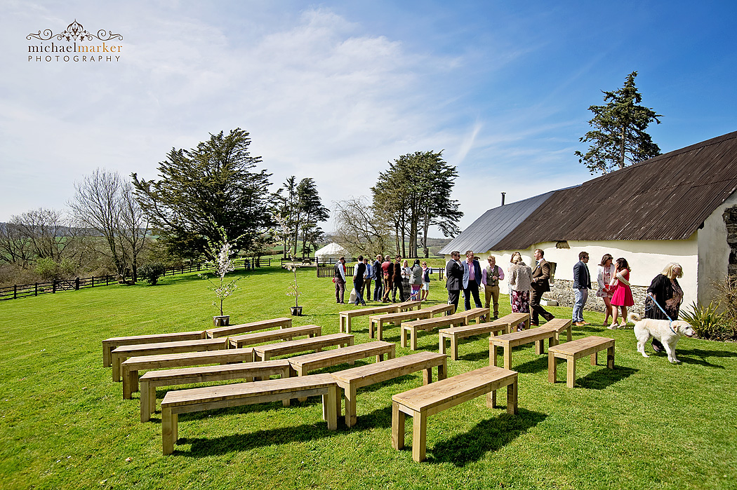 guesta arriving for wedding ceremony at Higher Eggbear Farn on the lawn.