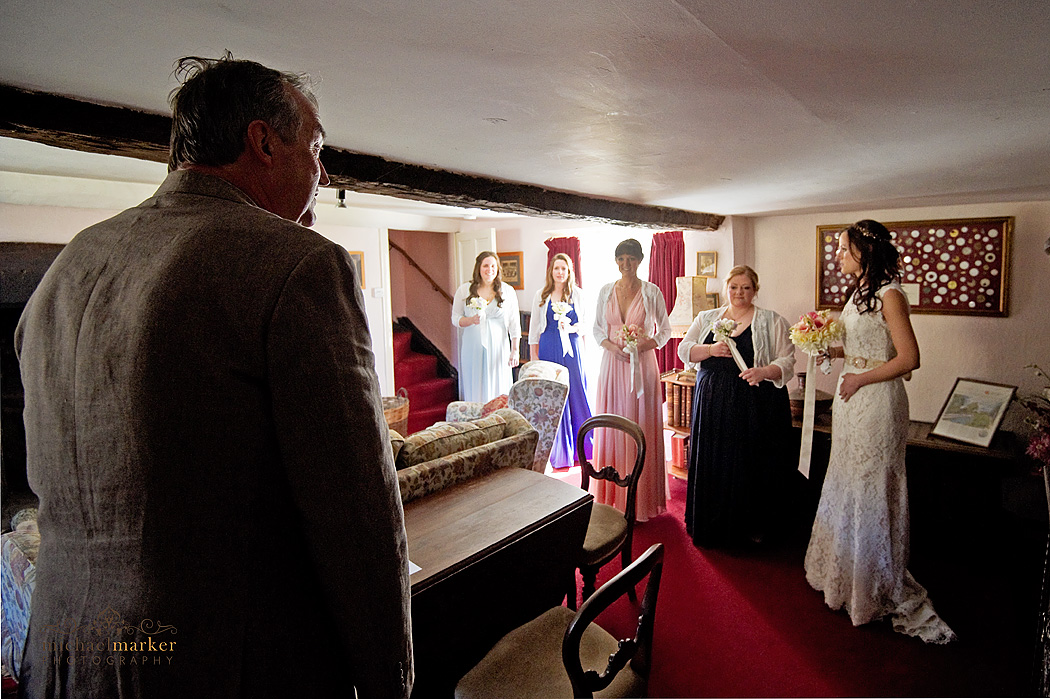 father of the bride sees his daughter in wedding dress for first time on her wedding day.