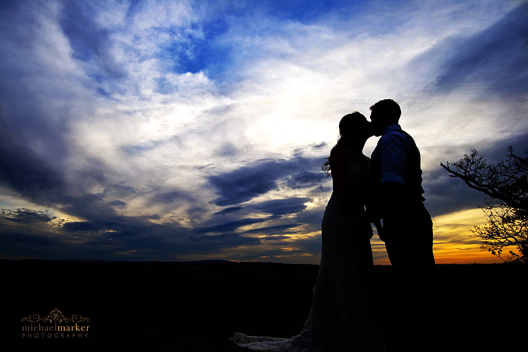 Higher Eggbeer wedding sunset silhouette kiss by bride and groom.