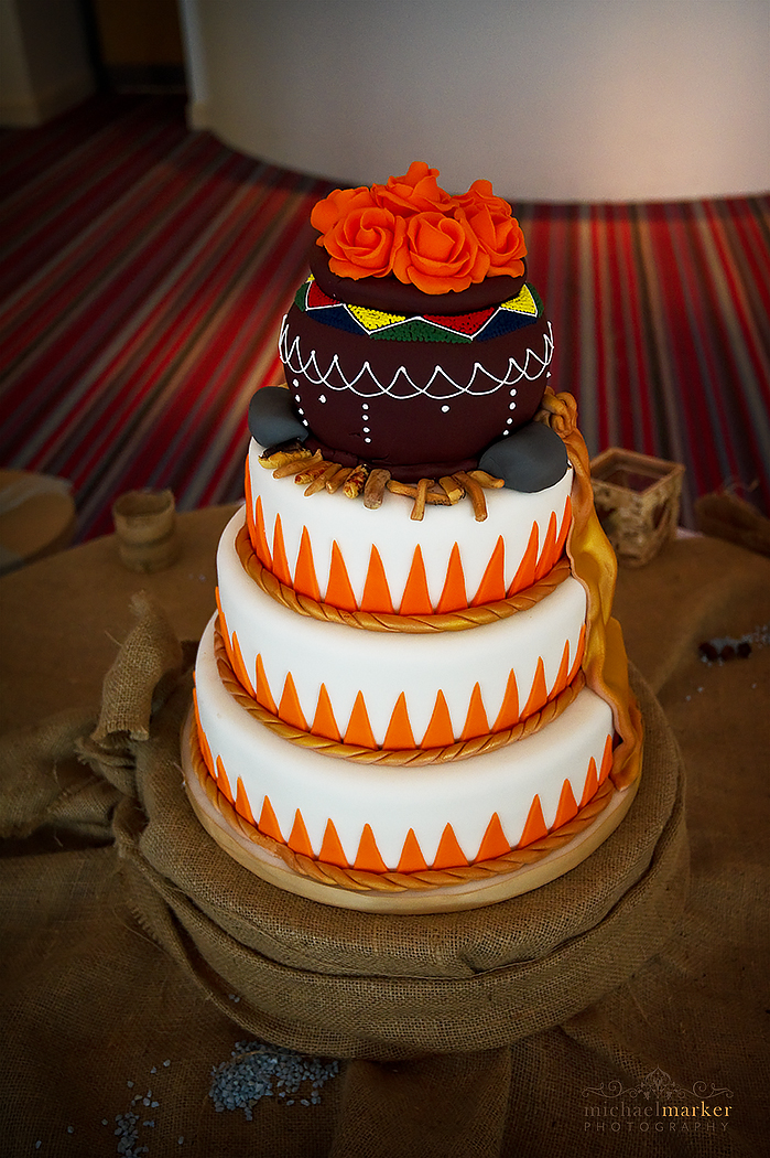 African themed wedding cake with Orange and white.