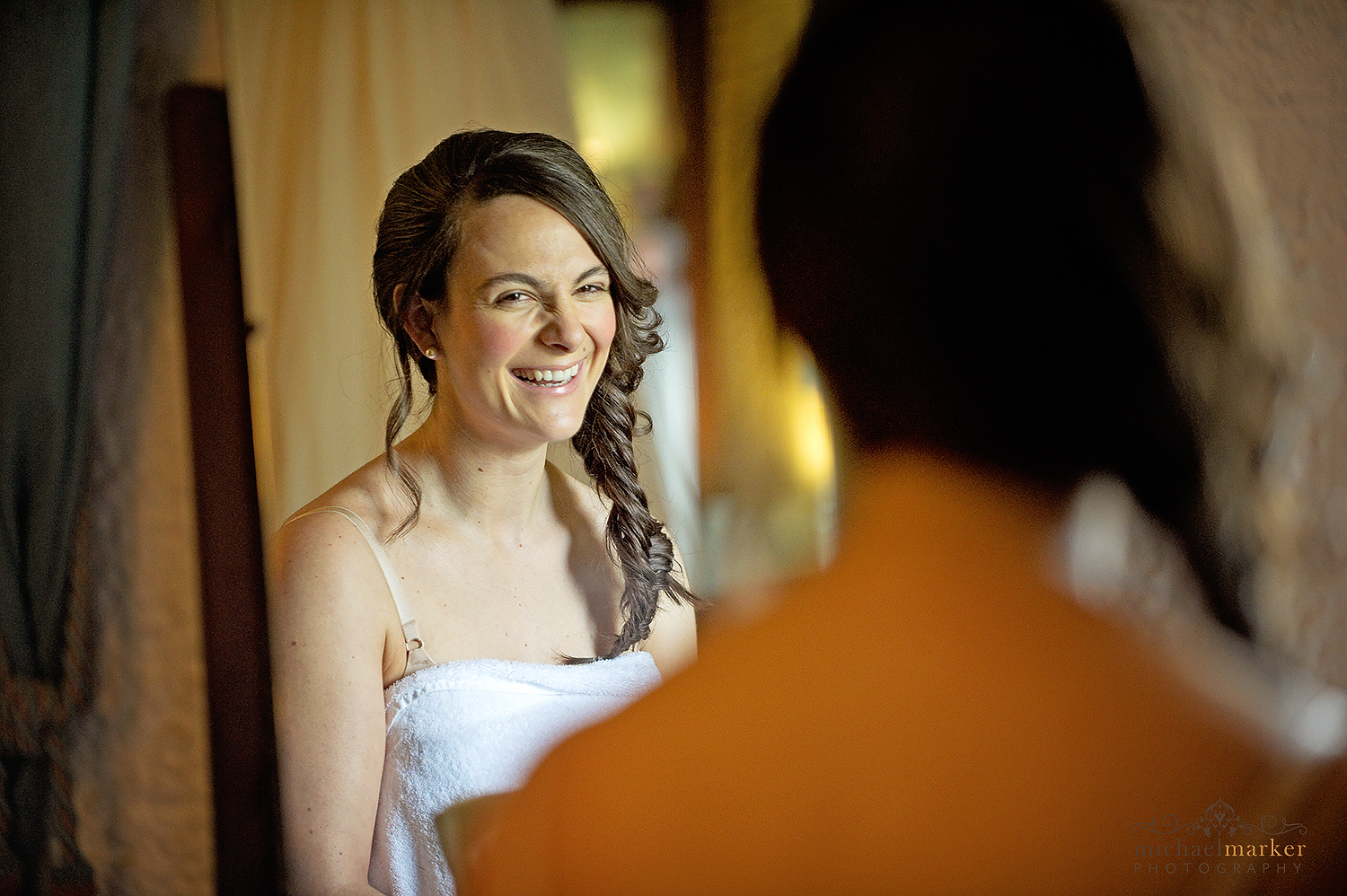 Bride laughing whilst getting ready for her wedding at Polhawn