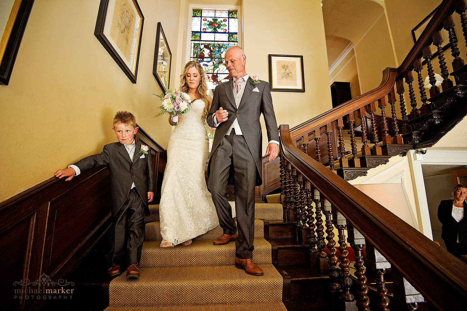 Bride and father walk down the stairs at Lamgdon Court near Wembury