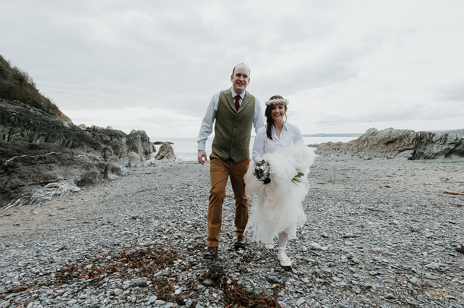 Bride and groom on beach at Polhawn wedding