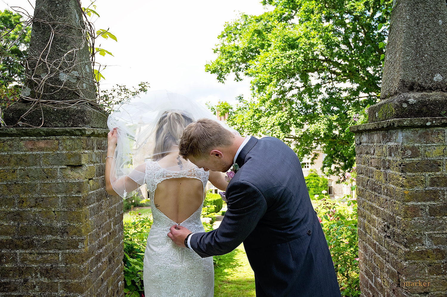 groom-checking-the-wedding-dress