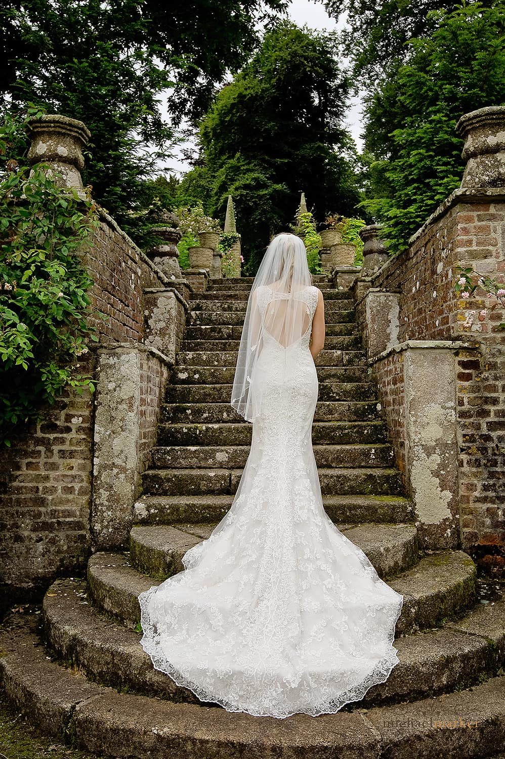 Beautiful bride on steps at Langdon court