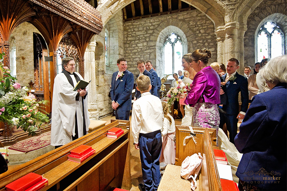 Groom's first look of his bride to be in Lydford church