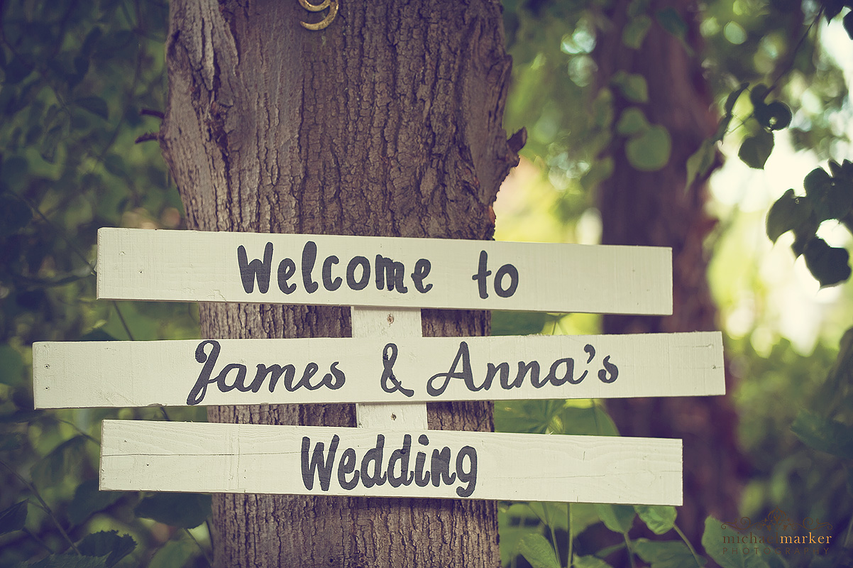 DIY wedding sign attached to a tree