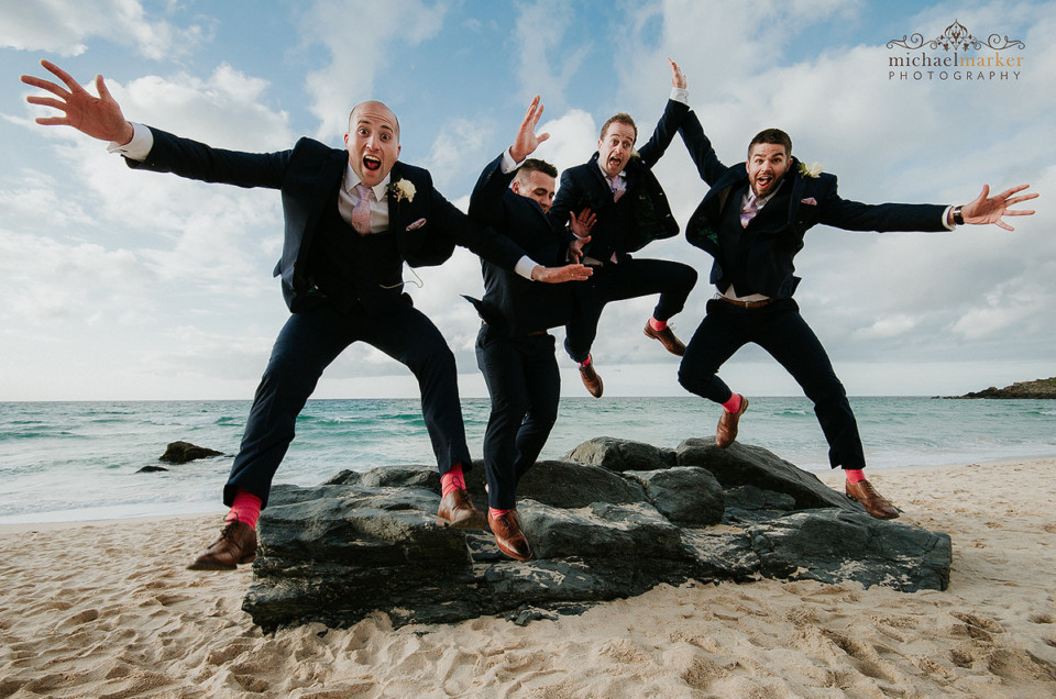 Groomsmen jumping towards the camera lens at St Ives Easter wedding