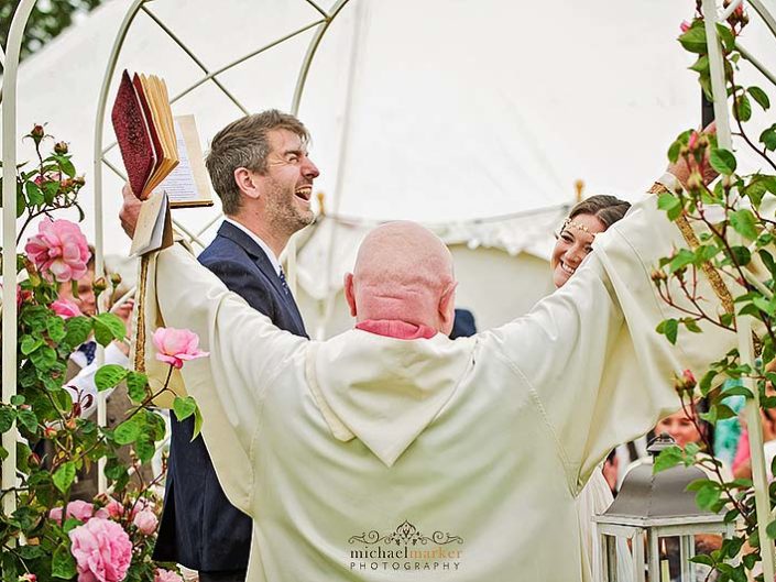 Vicar and groom celebrate wedding vows at Devon outdoor wedding