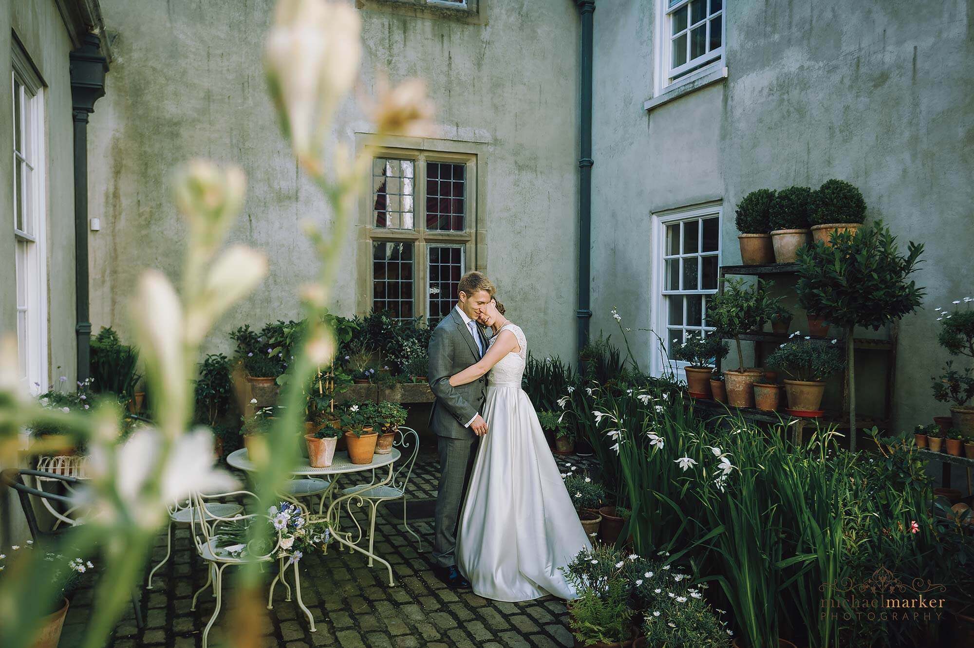 Bride and groom at beautiful Devon wedding venue Shilstone House courtyard.