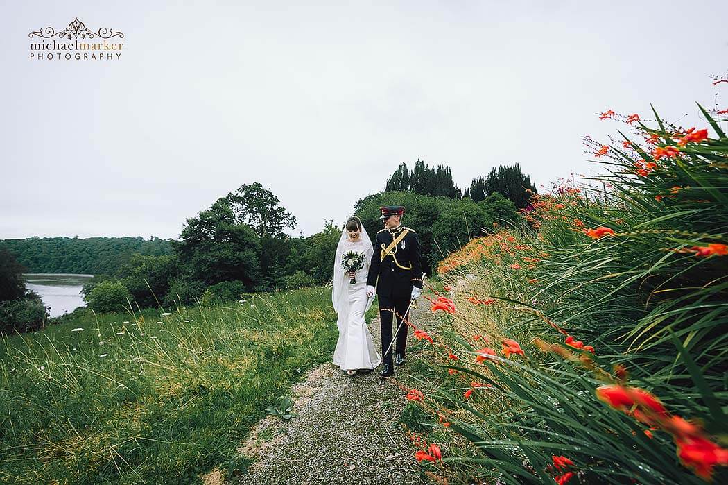 walking in gardens of Pentillie wedding by best Cornwall wedding photographer Michael Marker