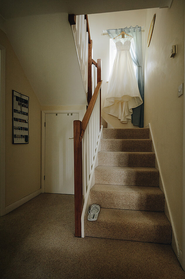 Bride wedding dress on the stairs at home