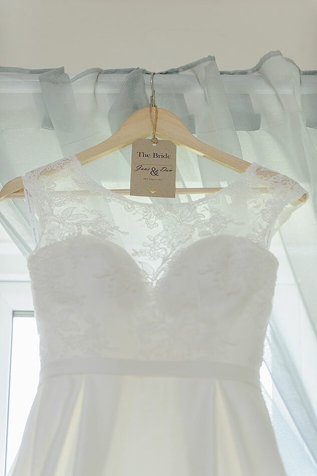 close up of wedding dress and vintage tag label