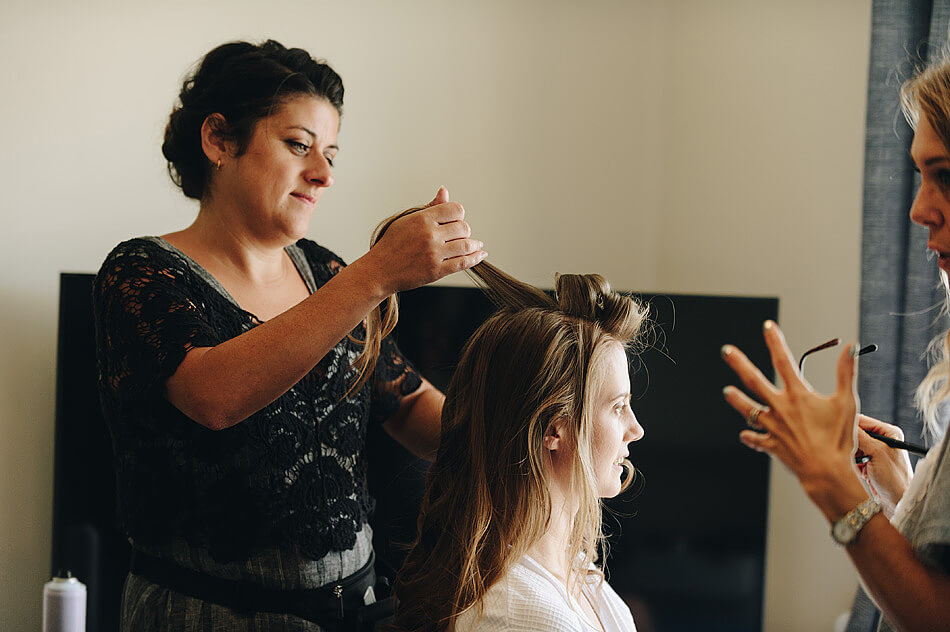 wedding hairstylist doing brides hair in Devon