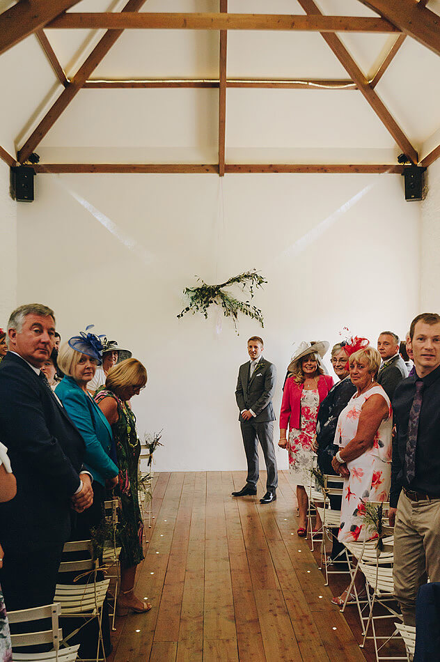 Groom looking down the aisle at Shilstone House wedding