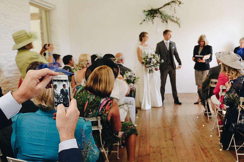 documentary wedding photo of bride and groom exiting the ceremony at Shilstone House 