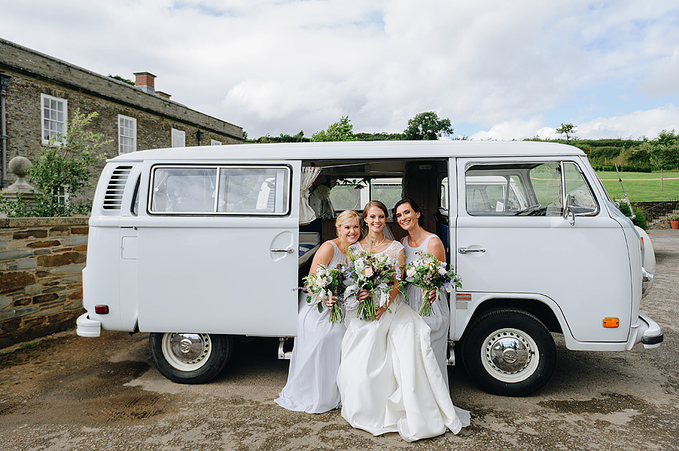 bride and bridesmaids in front of Shilstone House with campervan