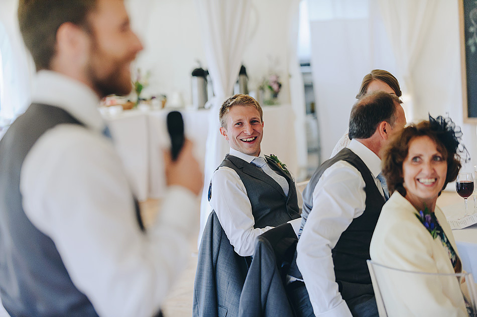 documentary wedding photo of groom laughing during the best man speech at Shilstone House