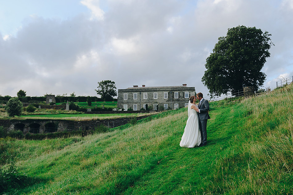 beautiful photo of bride and groom kissing in the fields at Shilstone House in Devon